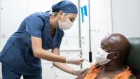 Nurse giving a vaccination shot to a patient